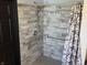 Updated shower featuring stylish gray tiling, safety bars, and a rainfall shower head at 6431 W 800 S, Pendleton, IN 46064