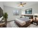 Bedroom featuring neutral tones, a ceiling fan, and a large window with outdoor views at 7220 Village Parkway Dr # 8, Indianapolis, IN 46254