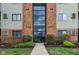 Brick building entrance featuring a glass facade and well-maintained landscaping and clearly visible address at 7220 Village Parkway Dr # 8, Indianapolis, IN 46254