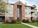 Inviting condo complex with brick facade, well-maintained lawn, and mature landscaping for a welcoming curb appeal at 7220 Village Parkway Dr # 8, Indianapolis, IN 46254