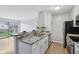 Bright kitchen with white cabinetry, granite countertops, and stainless steel appliances at 7220 Village Parkway Dr # 8, Indianapolis, IN 46254