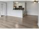 Open living area features modern flooring, neutral paint, and an attached kitchen with appliances and breakfast bar at 7220 Village Parkway Dr # 8, Indianapolis, IN 46254