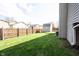 Landscaped and fenced backyard with green grass, shade, and a shed with other homes in the background at 726 Westridge S Dr, Noblesville, IN 46062