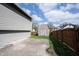 Spacious backyard with concrete patio, fenced in area, and wooden shed in the background at 726 Westridge S Dr, Noblesville, IN 46062