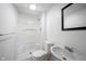 Bright bathroom with a shower-tub combo, toilet, sink, and framed mirror at 726 Westridge S Dr, Noblesville, IN 46062
