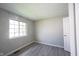 This bedroom has neutral paint, new luxury vinyl plank flooring, and a window for natural light at 726 Westridge S Dr, Noblesville, IN 46062