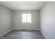 This bedroom has neutral paint, new luxury vinyl plank flooring, and a window at 726 Westridge S Dr, Noblesville, IN 46062