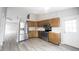 Kitchen features stainless steel appliances, wood cabinets, neutral paint, and new flooring at 726 Westridge S Dr, Noblesville, IN 46062