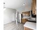 Open kitchen featuring stainless steel appliances, light wood cabinets, and vinyl flooring at 726 Westridge S Dr, Noblesville, IN 46062