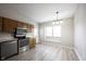Eat-in kitchen featuring stainless steel appliances, abundant light, and modern flooring at 726 Westridge S Dr, Noblesville, IN 46062
