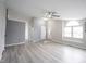 Spacious living room with new floors, a ceiling fan, and a large arched window at 726 Westridge S Dr, Noblesville, IN 46062