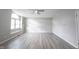 Open living room with new flooring, a ceiling fan, and a large arched window at 726 Westridge S Dr, Noblesville, IN 46062