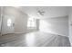 Bright living room featuring new flooring, a ceiling fan, and a large arched window at 726 Westridge S Dr, Noblesville, IN 46062
