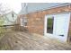 Exterior view of back deck featuring weathered planks, exterior wall, and sliding glass doors at 7421 Rogers Dr, Indianapolis, IN 46214