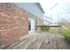 Exterior view of a weathered back deck, siding, and sliding glass doors at 7421 Rogers Dr, Indianapolis, IN 46214