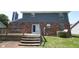 The home's rear exterior features a sliding glass door leading to a wooden deck and backyard at 7421 Rogers Dr, Indianapolis, IN 46214