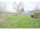 View of a spacious backyard with mature trees and a wood fence at 7421 Rogers Dr, Indianapolis, IN 46214