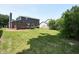 Spacious backyard with a well-maintained lawn and mature trees surrounding a two-story home at 7421 Rogers Dr, Indianapolis, IN 46214