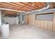 Large unfinished basement space showing utility connections, exposed pipes, and potential for customization at 7421 Rogers Dr, Indianapolis, IN 46214