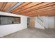 Unfinished basement featuring exposed ceiling beams, ample space, and a framed window at 7421 Rogers Dr, Indianapolis, IN 46214