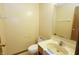 Modest bathroom featuring a sink, toilet, mirror, and towel rack at 7421 Rogers Dr, Indianapolis, IN 46214