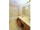 Bathroom featuring a double sink vanity, tile shower, and an open cabinet, offering plenty of storage space at 7421 Rogers Dr, Indianapolis, IN 46214