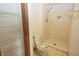 Full bathroom with shower stall, toilet, and white metal shelving at 7421 Rogers Dr, Indianapolis, IN 46214