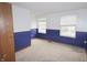 Bedroom with blue and white walls and two windows offering a creative canvas at 7421 Rogers Dr, Indianapolis, IN 46214