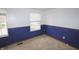Bedroom with two windows letting in natural light and lower walls with blue paint at 7421 Rogers Dr, Indianapolis, IN 46214