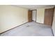 Bedroom with neutral walls, carpet, and closet space, ready for a new homeowner at 7421 Rogers Dr, Indianapolis, IN 46214