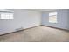 Bright bedroom with carpet, neutral paint, and natural light from two windows at 7421 Rogers Dr, Indianapolis, IN 46214