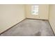 Bedroom featuring neutral walls, window, and hardwood floor space, ready for a new homeowner at 7421 Rogers Dr, Indianapolis, IN 46214