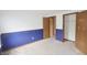 Bedroom featuring blue and white walls, carpet, and closet space, ready for a new homeowner at 7421 Rogers Dr, Indianapolis, IN 46214