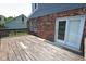 View of wooden deck with access to home, nestled in a grassy, fenced backyard for outdoor enjoyment at 7421 Rogers Dr, Indianapolis, IN 46214