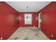 Dining room with red walls, an ornate chandelier, and a glimpse into the kitchen at 7421 Rogers Dr, Indianapolis, IN 46214