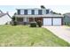 Charming two-story home with a brick and siding exterior and a well-manicured lawn at 7421 Rogers Dr, Indianapolis, IN 46214