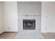 Floor-to-ceiling tile fireplace in a living room featuring damaged carpet and freshly painted walls at 7421 Rogers Dr, Indianapolis, IN 46214