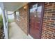 Close-up of the front door on a covered porch with brick columns at 7421 Rogers Dr, Indianapolis, IN 46214