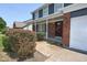 Charming two-story home featuring a brick facade, covered porch, and well-maintained landscaping at 7421 Rogers Dr, Indianapolis, IN 46214