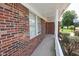 Angle view of front porch with red brick walls and concrete walkway at 7421 Rogers Dr, Indianapolis, IN 46214