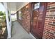 View of front brick porch with white posts and a door, offering a welcoming entrance at 7421 Rogers Dr, Indianapolis, IN 46214