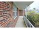 Brick home featuring an inviting covered front porch with a well-manicured landscape at 7421 Rogers Dr, Indianapolis, IN 46214