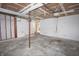 Spacious garage with bare drywall and unfinished ceiling, with a door leading into the home at 7421 Rogers Dr, Indianapolis, IN 46214