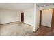 Spacious living room with outdated carpet, base trim, and natural light streaming in at 7421 Rogers Dr, Indianapolis, IN 46214