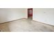 Living room showing an interior door and neutral walls, requiring TLC at 7421 Rogers Dr, Indianapolis, IN 46214