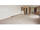 Living room featuring carpet flooring with kitchen access, a sliding door, and a hallway at 7421 Rogers Dr, Indianapolis, IN 46214