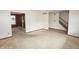 Open living room featuring access to the kitchen, stairway, and neutral paint at 7421 Rogers Dr, Indianapolis, IN 46214