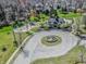 Beautiful aerial view of a neighborhood clubhouse with playground and circular driveway with central fountain feature at 7957 Preservation Dr, Indianapolis, IN 46278