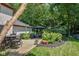 A backyard patio offers a relaxing outdoor living space, featuring a dining table, lounge chairs, and lush landscaping at 7957 Preservation Dr, Indianapolis, IN 46278