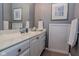 Well-lit bathroom featuring a marble-top vanity, mirrored wall, and framed artwork at 7957 Preservation Dr, Indianapolis, IN 46278